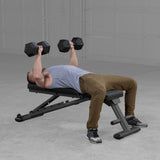Body-Solid GFID225B bench in use with dumbbells