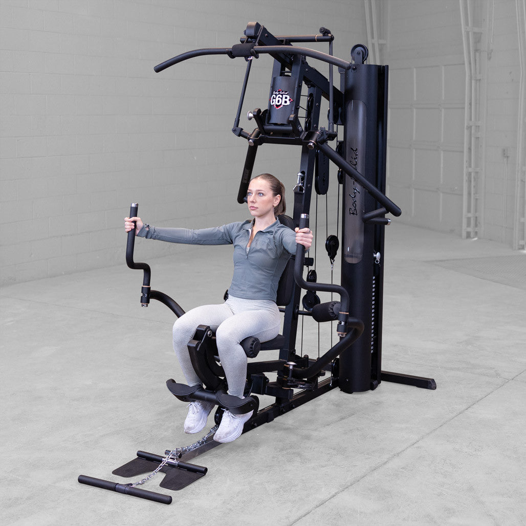 Body-Solid G6B gym in use with seated chest fly