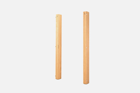 Two folded pale-oak wall racks standing upright, with silver hinges along the seam