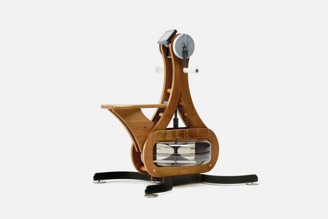 Cherry wood arm bike ergometer with clear water tank, white crank handles and wooden seat, front three-quarter view