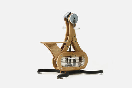 Oak wood arm bike ergometer with clear water tank, white crank handles and wooden seat, front three-quarter view